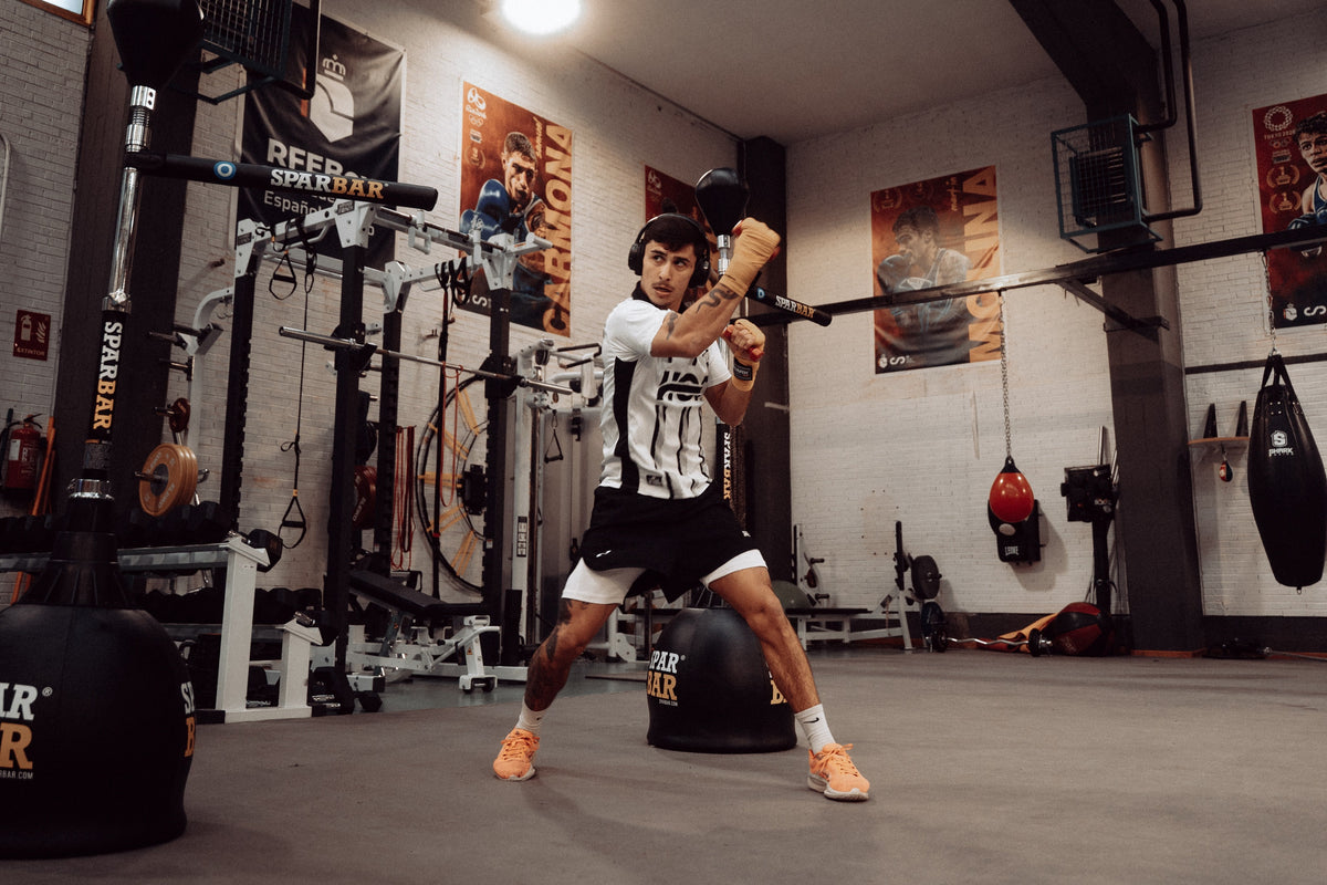 Boxer in a boxing gym with boxing clothes throwing a punch